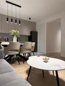 a living room with a table and a kitchen at Apartman Royal in Posušje +37 photos