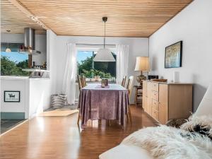 a kitchen and dining room with a table in a room at 6 person holiday home in Borre in Borre