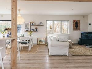a living room with a white couch and a table at 6 person holiday home in Rude in Rude