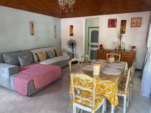 a living room with a table and a couch at Bleu Ocean in Deshaies