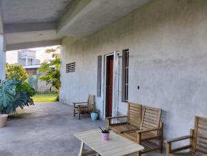 a patio with two chairs and a table and a porch at Suite Premium Perico Jujuy con Parking in Establecimiento La Candelaria