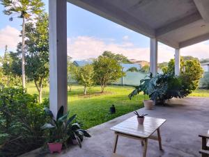 a porch with a table and a view of a field at Suite Premium Perico Jujuy con Parking in Establecimiento La Candelaria