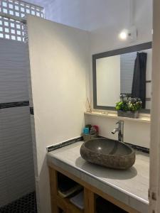 a bathroom with a sink and a mirror at Maison Petit Paradis in Basse-Terre +12 photos