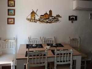 a dining room with a wooden table and chairs at Casa Rural La Simona in Belmonte