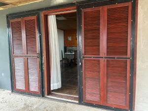 an open door of a house with wooden doors at El Regreso in Chuí