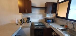 a kitchen with a sink and a counter top at TajiS Diani Chic 1 BR with swimming pool in Diani Beach