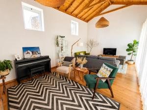 a living room with a couch and a fireplace at Casa dos Caldeiras in Lajes do Pico
