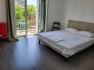 a bedroom with a bed and a large window at Castle View #3-4 in Kavála