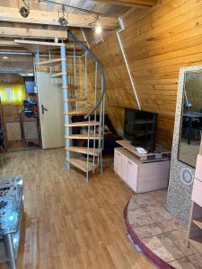 a living room with a spiral staircase in a cabin at Vikendice Garić in Veliko Gradište +12 photos