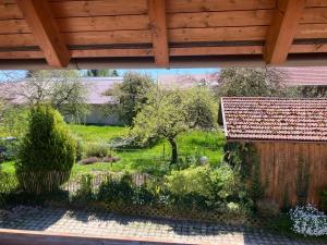 a view of a garden from the porch of a house at Ferienwohnung Eble bei Markt Rettenbach in Markt Rettenbach