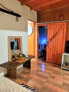 a room with a wooden door and a table with a mirror at Reina Mar Jacuzzi Exclusivo in Barra de Portezuelo