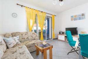 a living room with a couch and a tv at Apartments by the sea Maslinica, Solta - 14748 in Maslinica