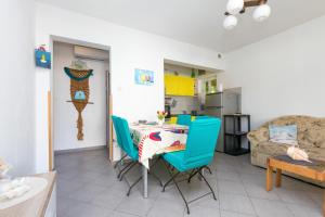 a kitchen and living room with a table and chairs at Apartments by the sea Maslinica, Solta - 14748 in Maslinica +14 photos
