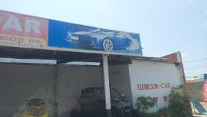 a billboard with a car on top of a building at pousada mar livre in Aracaju