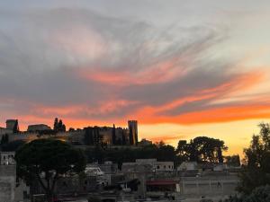 a city skyline with a sunset in the background at Casa Maria in Oria