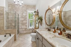 a bathroom with two sinks and a tub and a toilet at Shopkeeper's Inn in Fredericksburg +25 photos