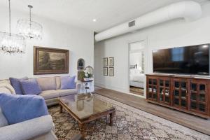 a living room with a large flat screen tv at Shopkeeper's Inn in Fredericksburg