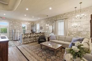 a living room with a couch and a table at Shopkeeper's Inn in Fredericksburg