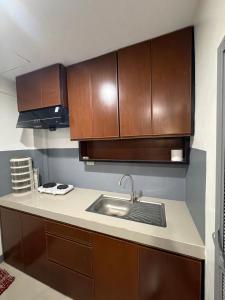 a kitchen with a sink and wooden cabinets at stayhouse in Gapan +10 photos