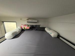 a room with two pillows and a camera on the floor at stayhouse in Gapan