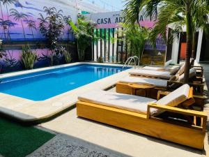 a swimming pool with chaise lounges and a swimming pool at Casa Arizona in Brisas de Zicatela