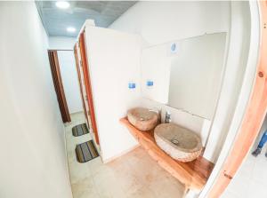 a bathroom with two sinks and a mirror at Bora Bora Hostal y Pasadías in Manaure