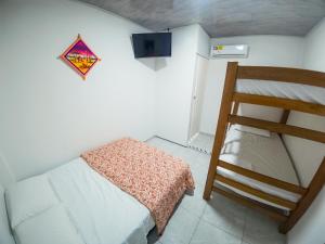 a small room with a bed and a ladder at Bora Bora Hostal y Pasadías in Manaure