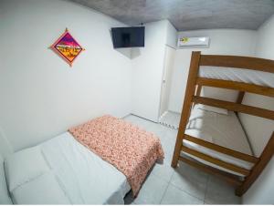 a small bedroom with a bunk bed and a ladder at Bora Bora Hostal y Pasadías in Manaure