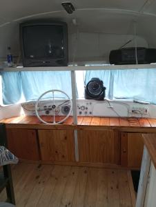 an inside view of a boat with a tv and controllers at Mostepa in Carpintería +9 photos