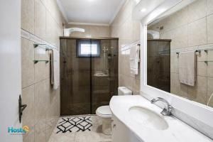 a bathroom with a toilet and a sink and a shower at Casa grande e aconchegante in Encantado +11 photos