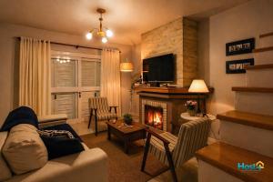 a living room with a couch and a fireplace at Casa grande e aconchegante in Encantado