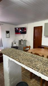 a kitchen with a counter top and a table at BRISAN descanso sol,y playa in Barra del Chuy