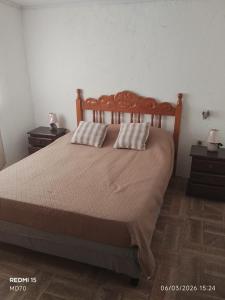 a bedroom with a bed with two pillows on it at BRISAN descanso sol,y playa in Barra del Chuy