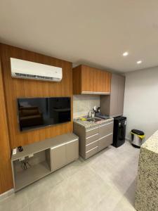 a kitchen with a sink and a counter top at Carneiros Pernambuco in Tamandaré
