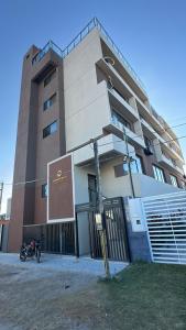 a building with a motorcycle parked in front of it at Carneiros Pernambuco in Tamandaré +4 photos