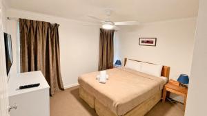 a hotel room with a bed and a window at Escape to 39 at Cape View in Busselton +24 photos