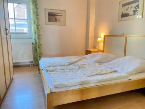 a bedroom with a bed in a room with a window at Ferienwohnung in Orth auf Fehmarn in Orth