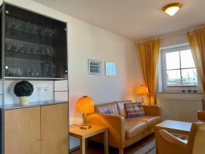 a living room with a couch and a table at Ferienwohnung in Orth auf Fehmarn in Orth