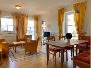 a living room with a table and chairs at Ferienwohnung in Orth auf Fehmarn in Orth
