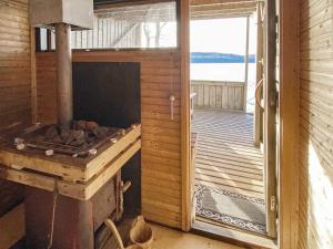 a woodburning stove in a room with a deck at 6 person holiday home in Ucklum-By Traum in Ucklum