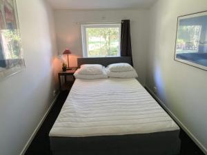 two beds in a small room with a window at 6 person holiday home in Ucklum-By Traum in Ucklum