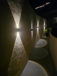 a row ofools with lights on a wall at Punta Peñasco Villas in Zihuatanejo +24 photos