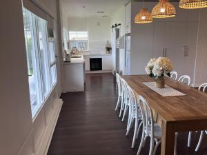 a dining room with a long table and chairs at 28 Ozone Victor Harbor in Victor Harbor