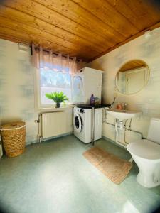 a bathroom with a sink and a washing machine at Spacious House for Families & Workers in Skelleftehamn