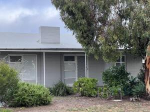 a white house with bushes in front of it at 28 Ozone Victor Harbor in Victor Harbor