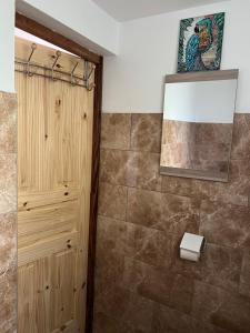 a bathroom with a shower and a wooden cabinet at Instant Locatif in Gourbeyre +7 photos