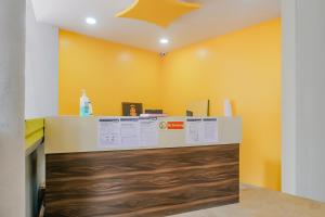 a counter in a room with a yellow wall at Hotel O Rest Inn in Yeraoda