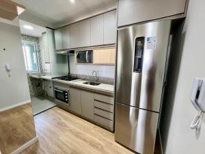 a kitchen with a stainless steel refrigerator at Apartamento com vista Jd Higienopolis in Bauru