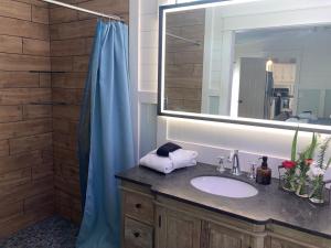 a bathroom with a sink and a mirror at Beaufort SC New Renovation, Close to Parris Island, Historic Downtown, Beautiful Beaches, Sleeps 6 in Beaufort +14 photos