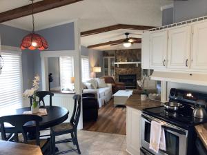 a kitchen and living room with a table and a couch at Beaufort SC New Renovation, Close to Parris Island, Historic Downtown, Beautiful Beaches, Sleeps 6 in Beaufort